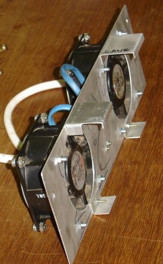 Two fans mounted on a plate.