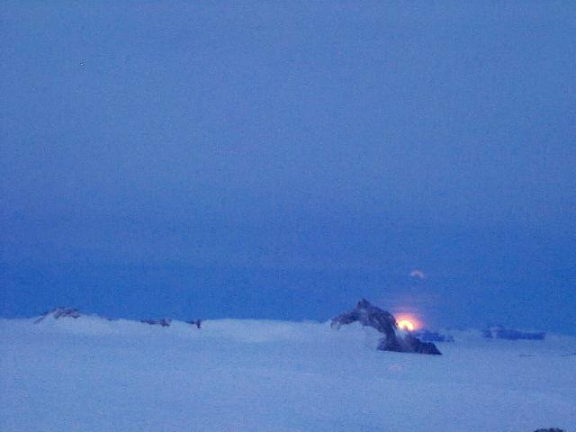 A picture of the moon disappearing behind Lorentzenpiggen