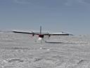De Havilland DHC-6 Twin Otter aircraft landing on snow.