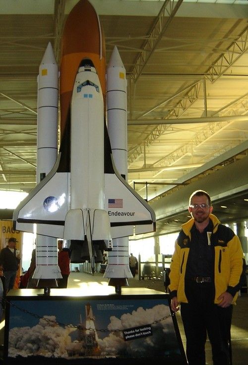 Niel Malan posing with a 1/15 th scale model of the Space Shuttle Endeavour at Houston Airport