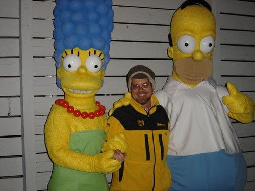 Niel Malan posing with two life-size Simpsons characters